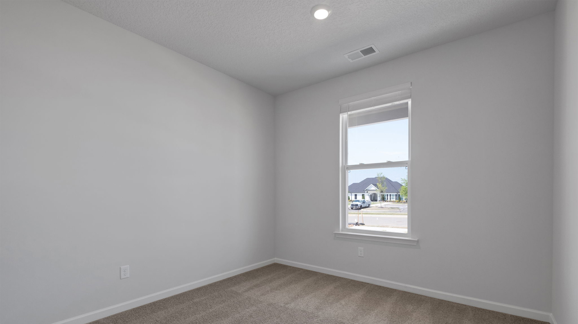 Bedroom four with a window overlooking the front yard