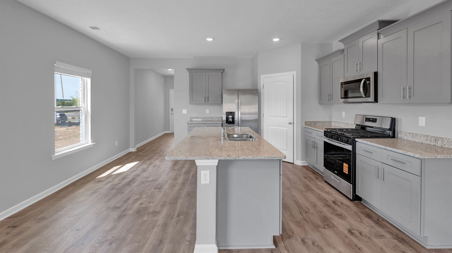 Open concept view of the front door leading into kitchen