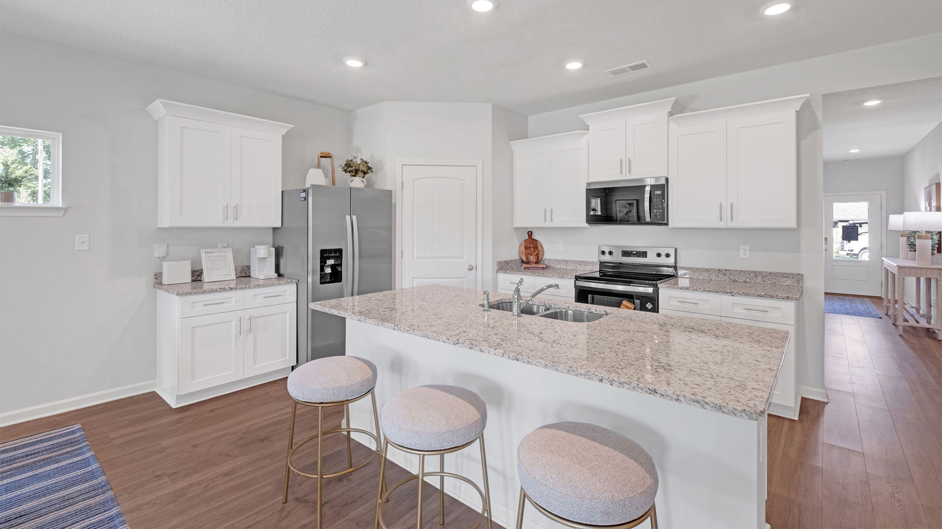 Kitchen area opens up at the end of entry hall