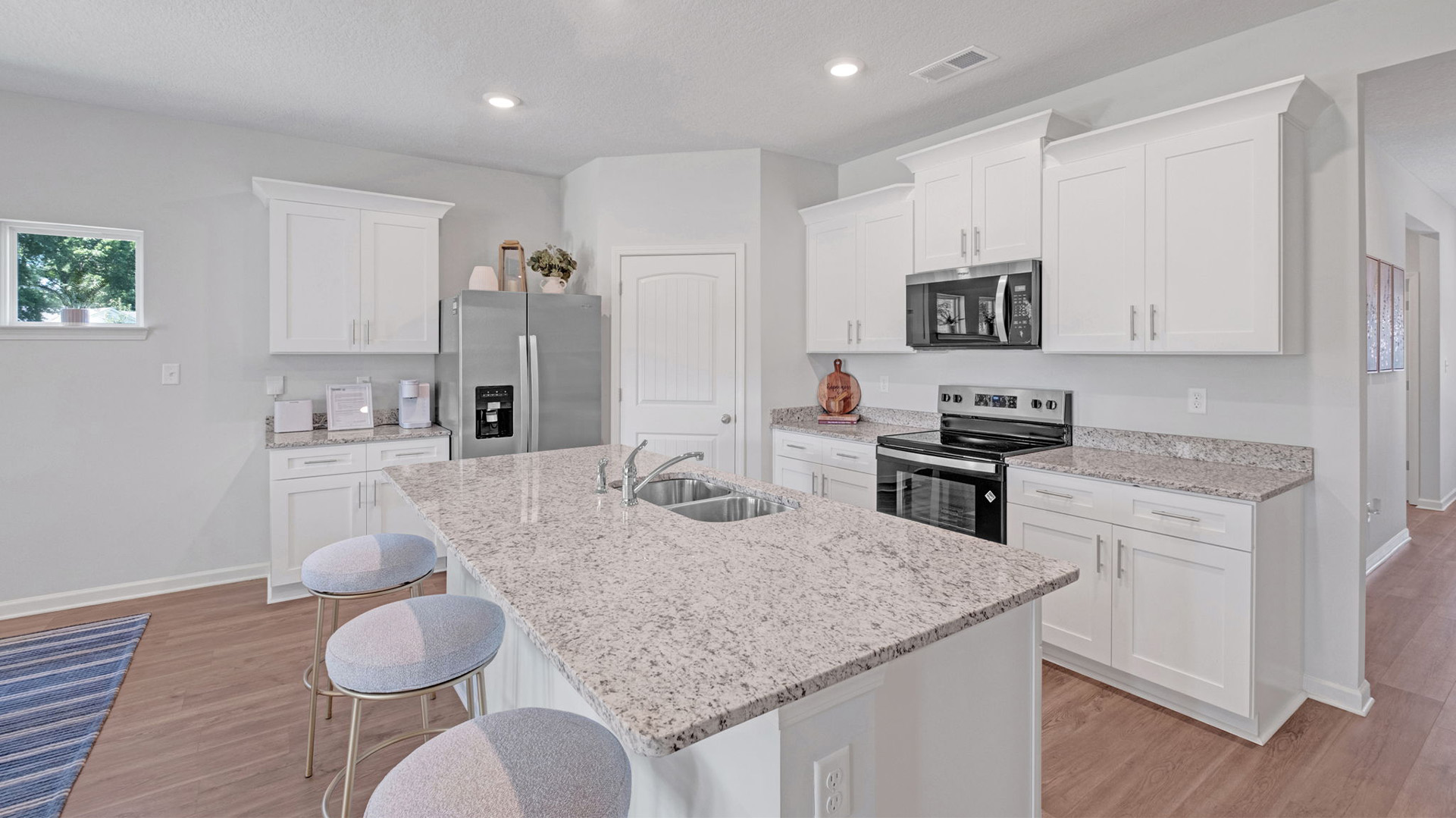 Beautiful kitchen with light cabinets and stainless steel appliances