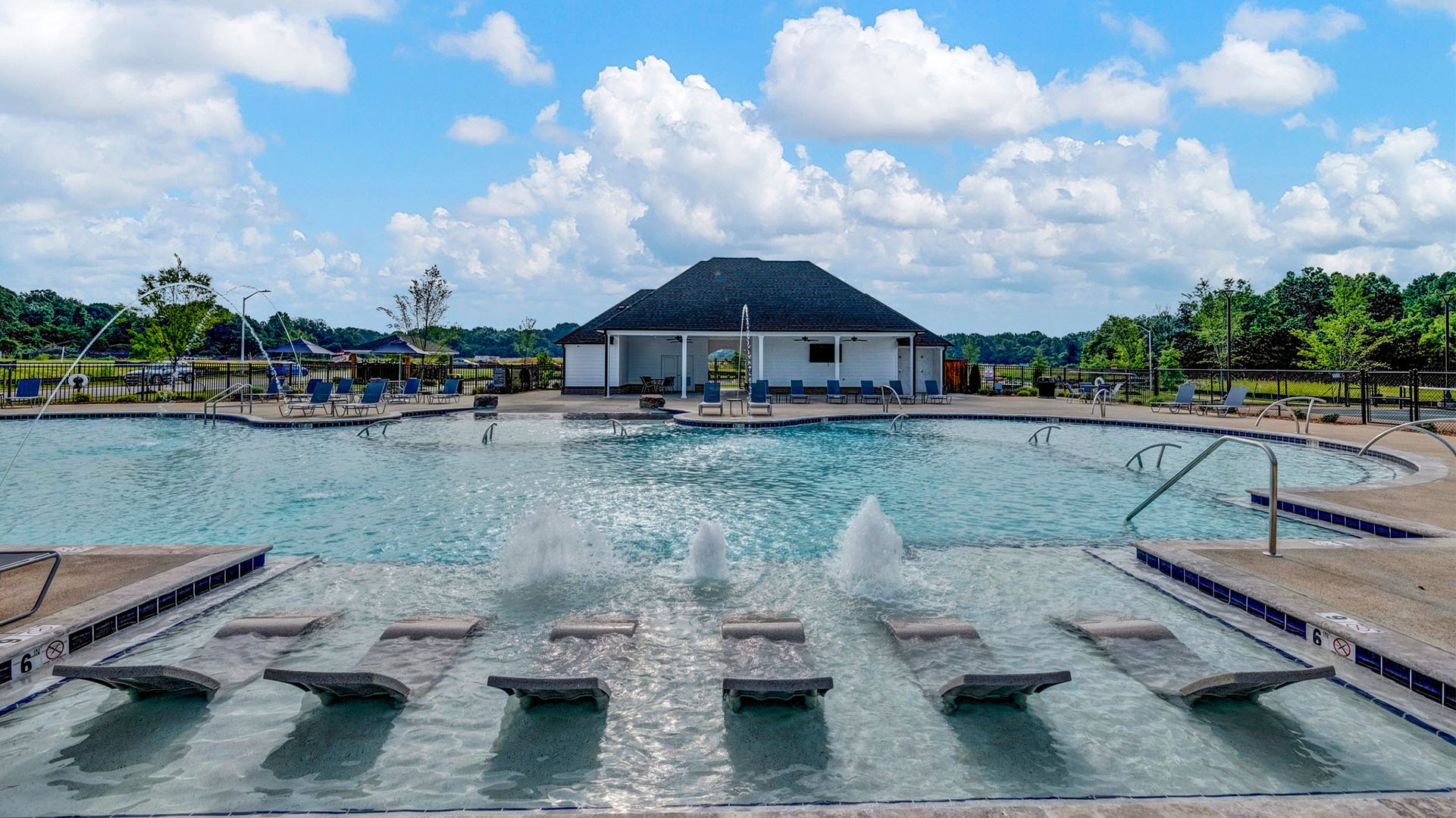 Community pool with layout chairs in the pool
