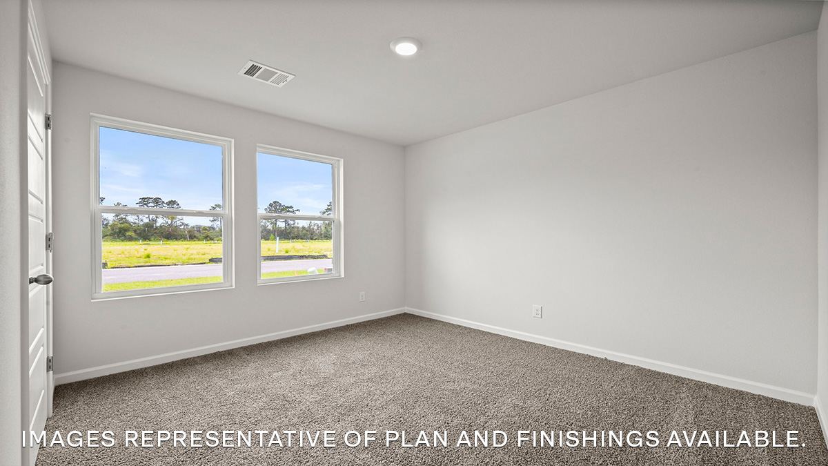 Second bedroom with a double window and carpet flooring