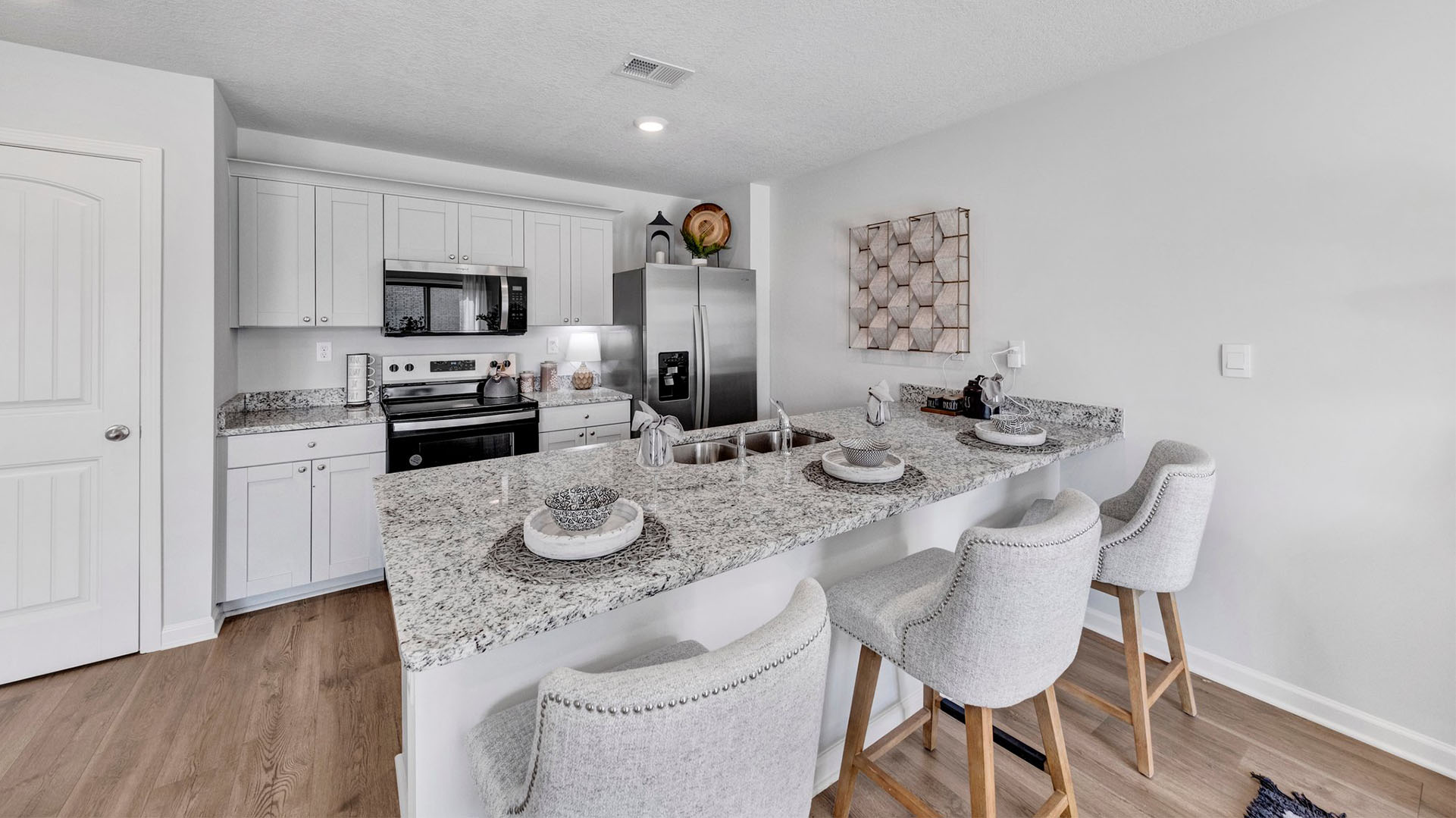 Kitchen area opens up at the end of entry hall