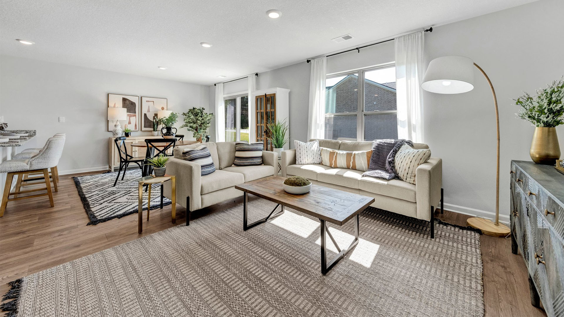 SPacious living room with vinyl flooring and neutral paint