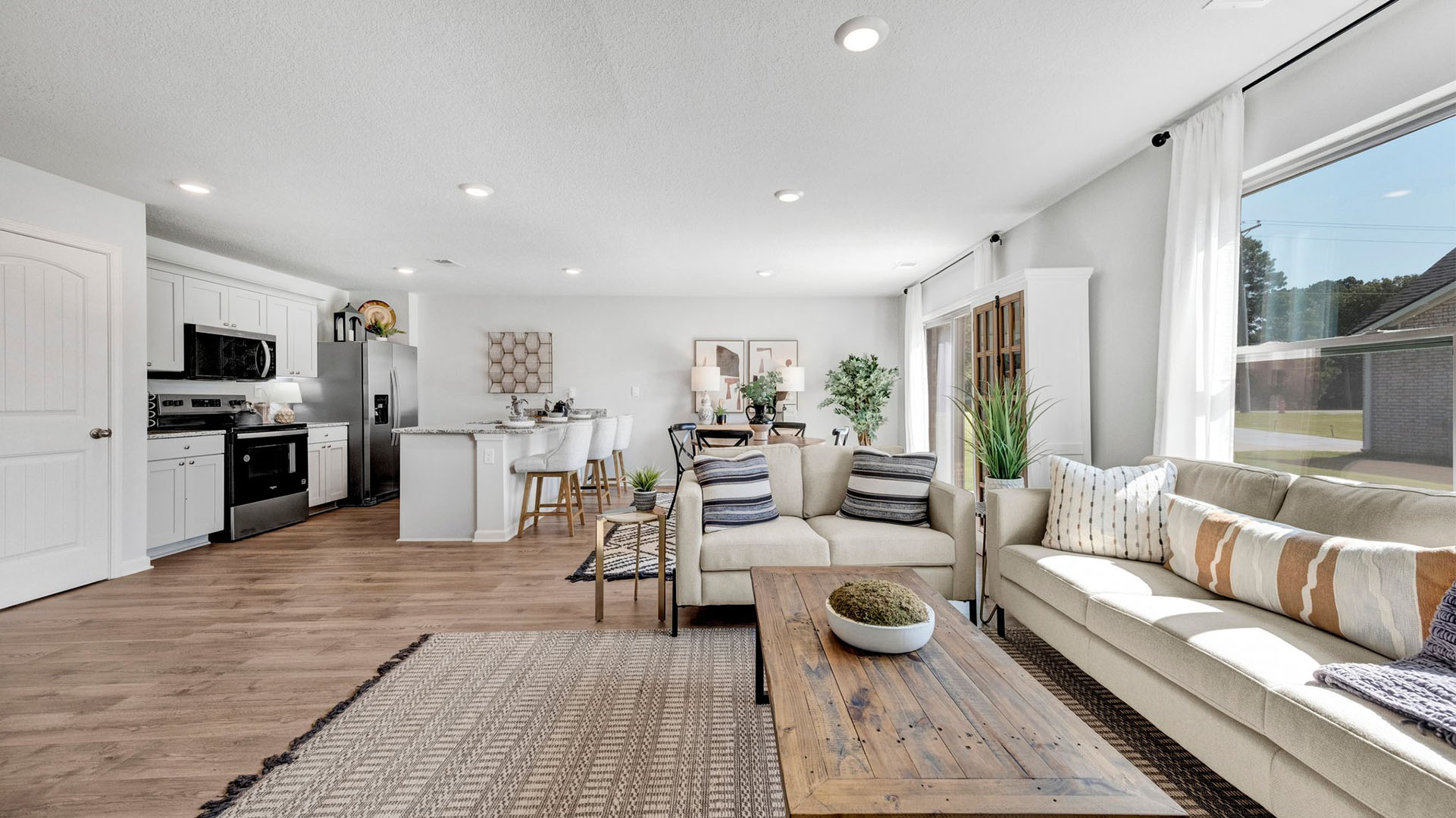Open concept view of the living room and dining room open to one another