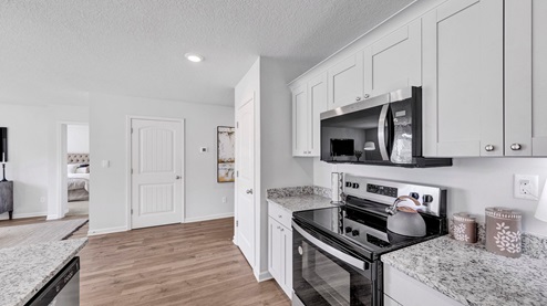 Kitchen area with granite countertops and stainless steel appliances