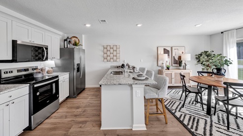 Open concept view of kitchen area opening up into the dining area