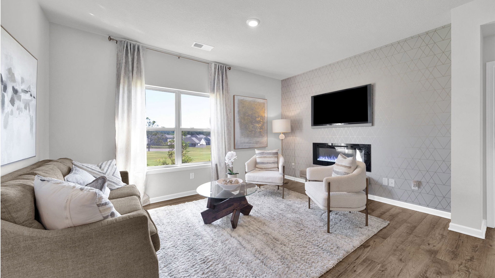 Living room with double window overlooking backyard