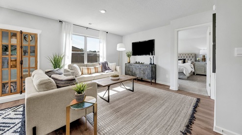 Spacious living room with vinyl flooring and neutral paint