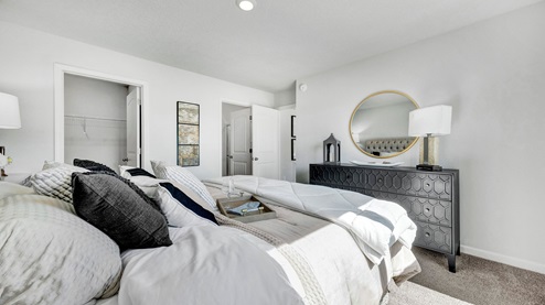 Primary bedroom comfortably fits a king size bed and additional bedroom furniture