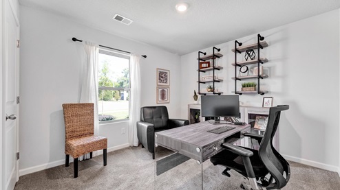 Second bedroom shown as a home office sitting at the front of the home