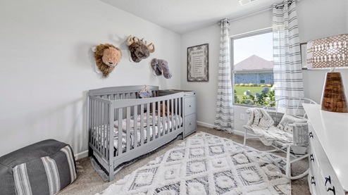Fourth bedroom shown as a nursery with a window overlooking the side yard