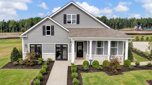 exterior of home with brick watertable, cementitious siding, and large covered front porch