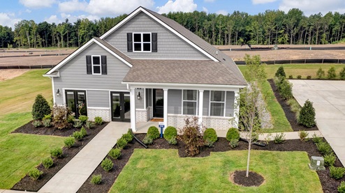 exterior of home with brick watertable, cementitious siding, and large covered front porch