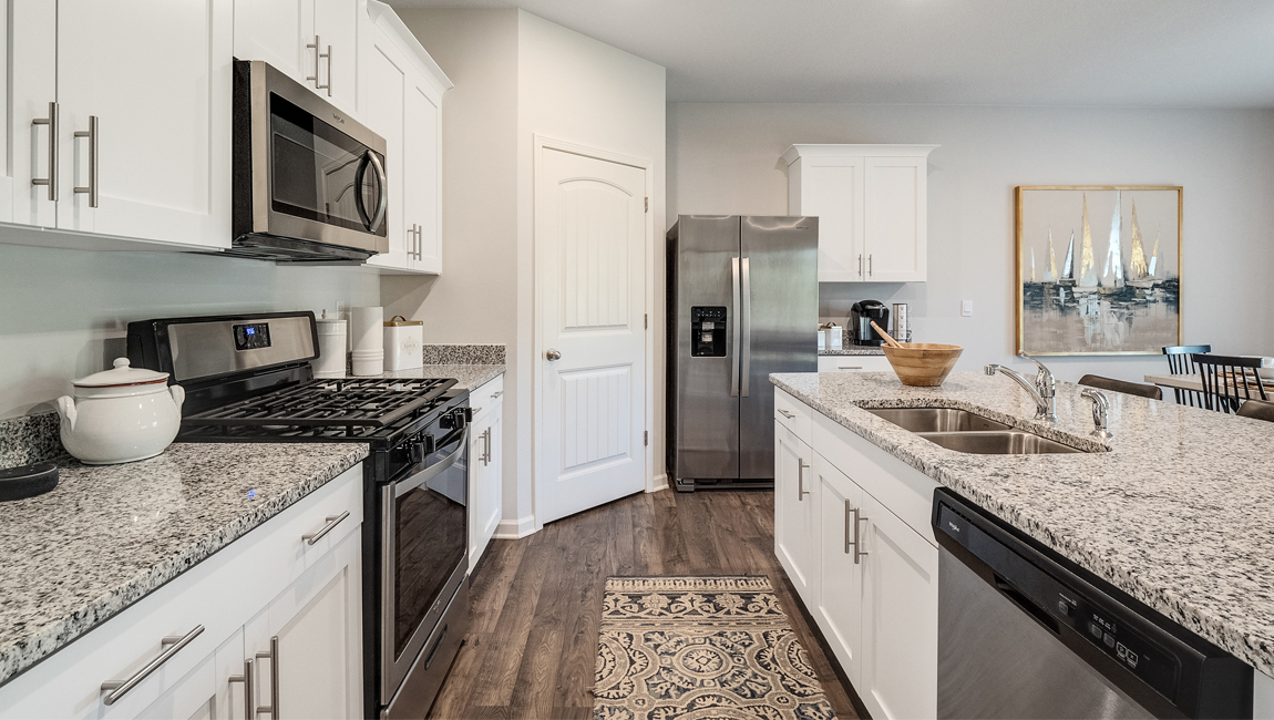 lacombe floorplan in indian oaks community kitchen with granite counters and stainless steel appliances