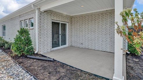 covered patio with sliding glass door off the dining area
