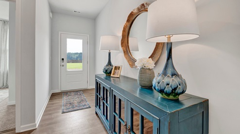 entry of home with window in front door allowing natural light in