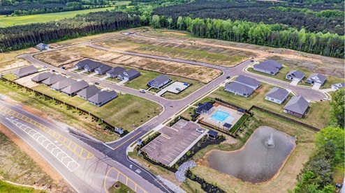 Drone shot of the Indian Oaks community featuring the community pool and neighborhood lake