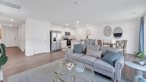 Living open with neutral walls and vinyl flooring
