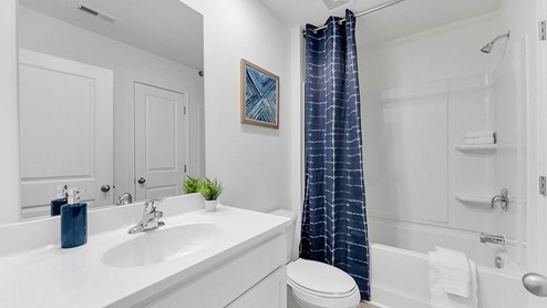 Bathroom with a single vanity and an acrylic tub/shower insert