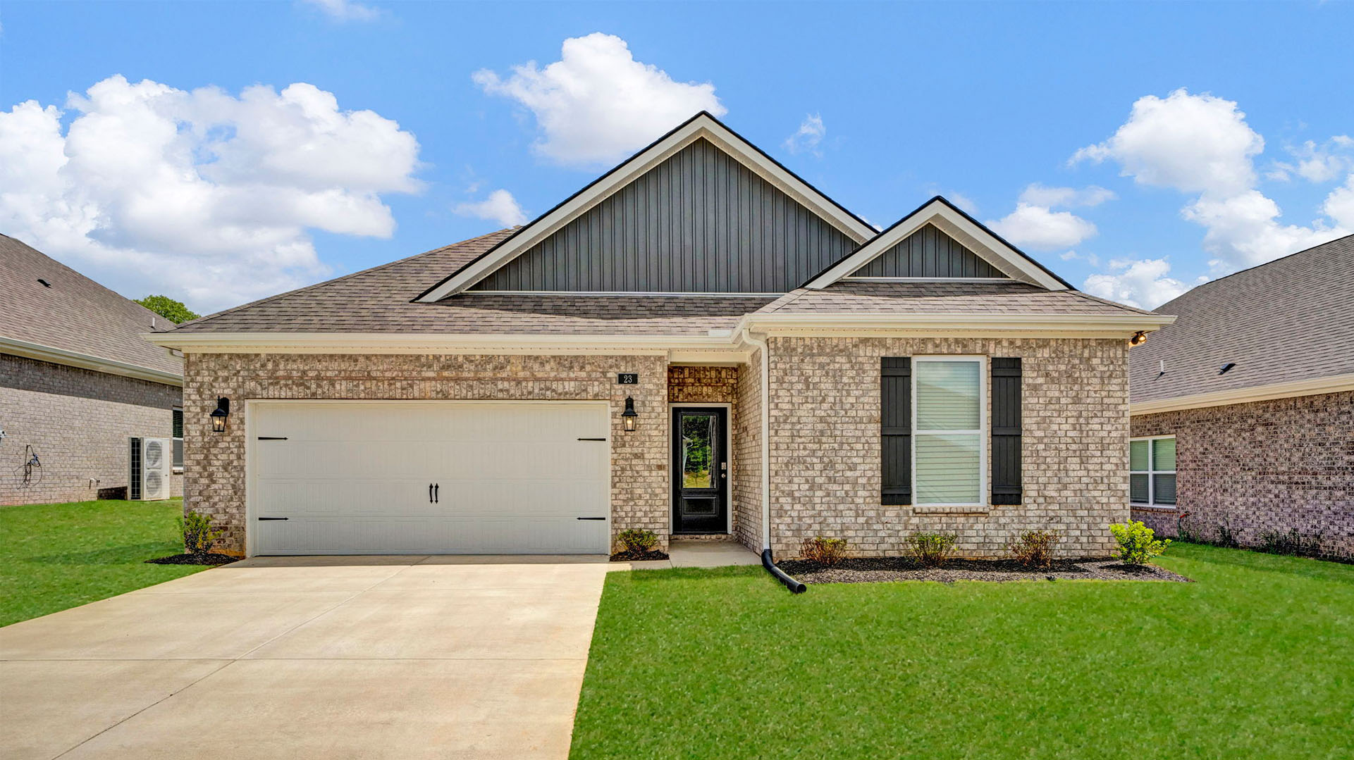 front exterior of a one story home with brick and grey siding