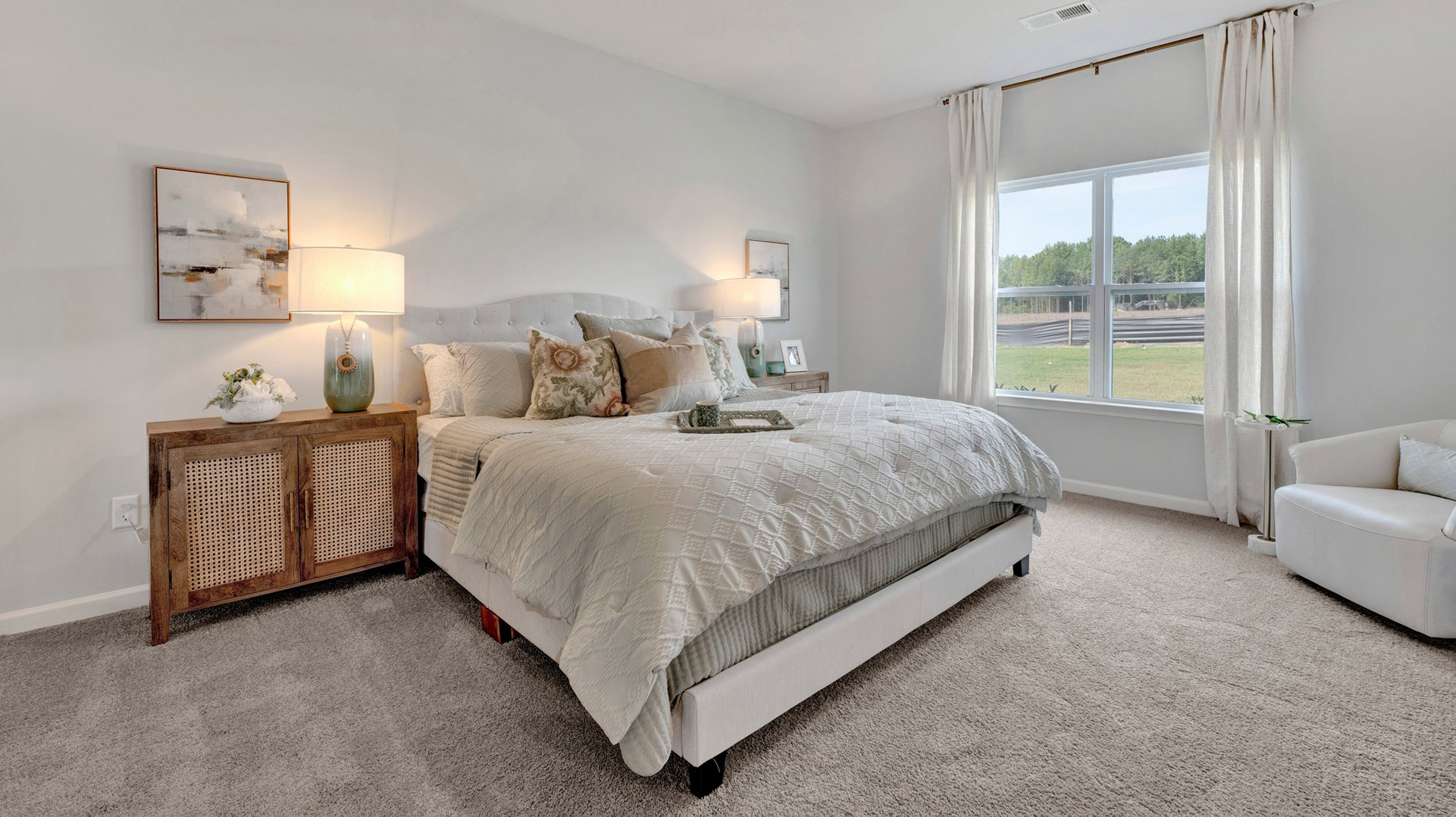 Primary bedroom with a double window overlooking the backyard