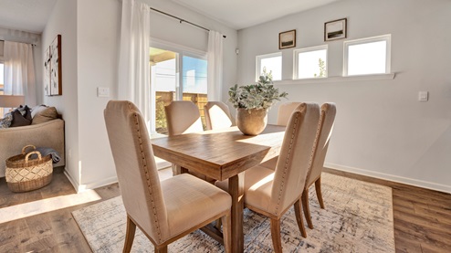 Dining area with picture window accents for extra added natural light