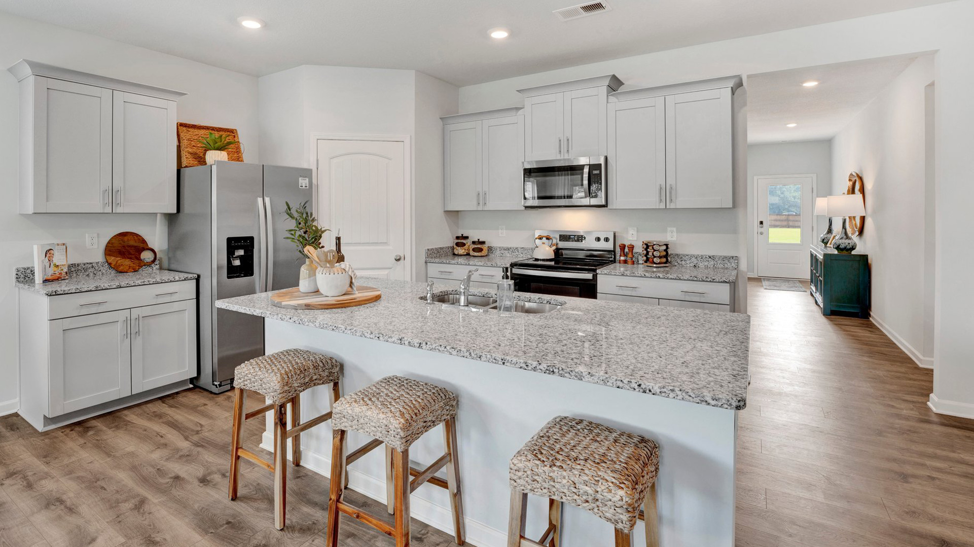 Beautiful kitchen opens up at the end of entry hall