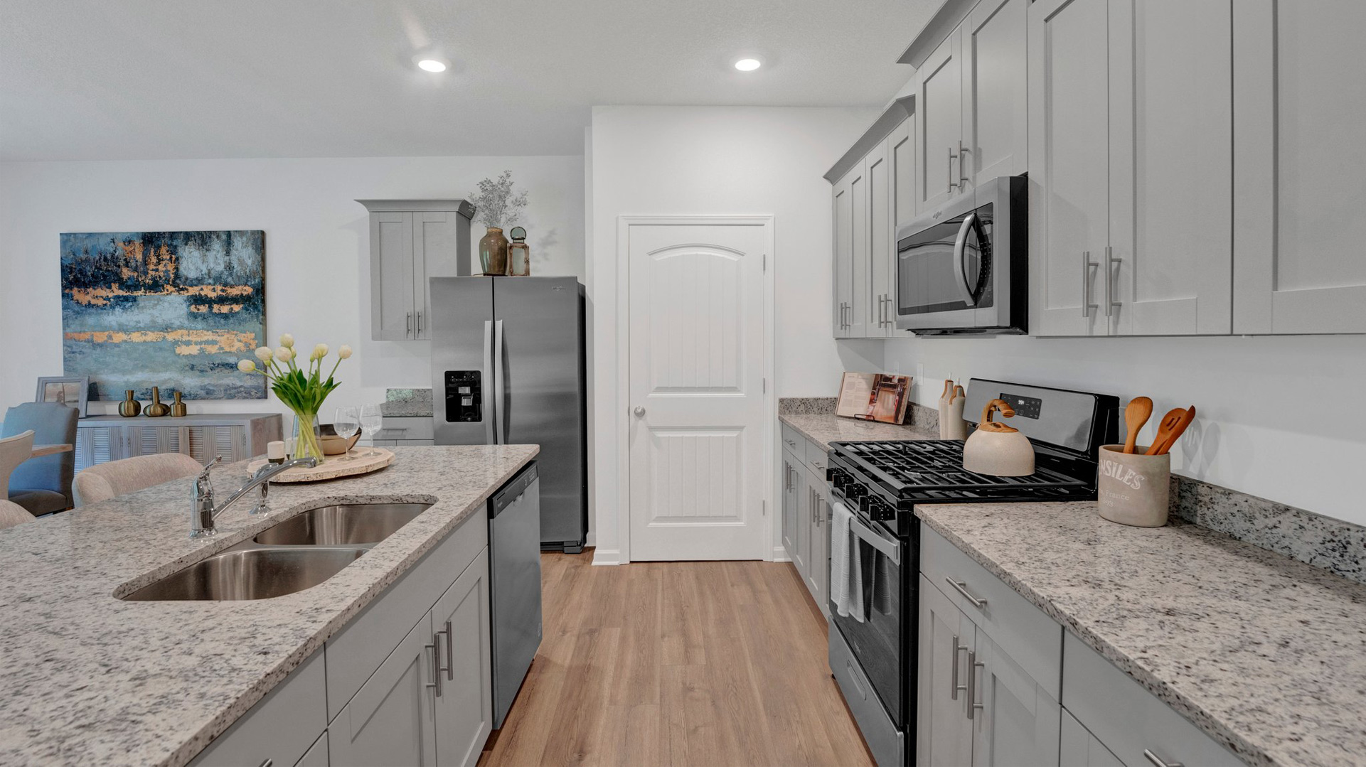 Beautiful kitchen opens up at the end of entry hall