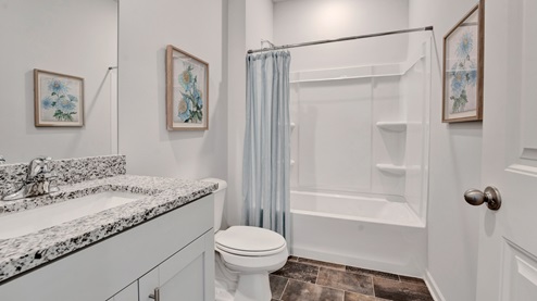 Second bathroom with a single vanity and an acrylic tub/shower insert