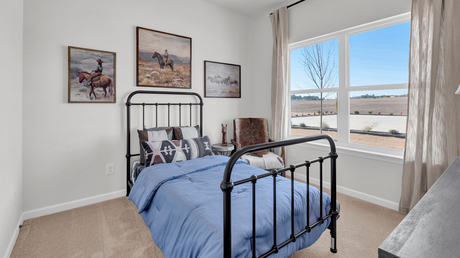 Bedroom three with carpet flooring and neutral paint