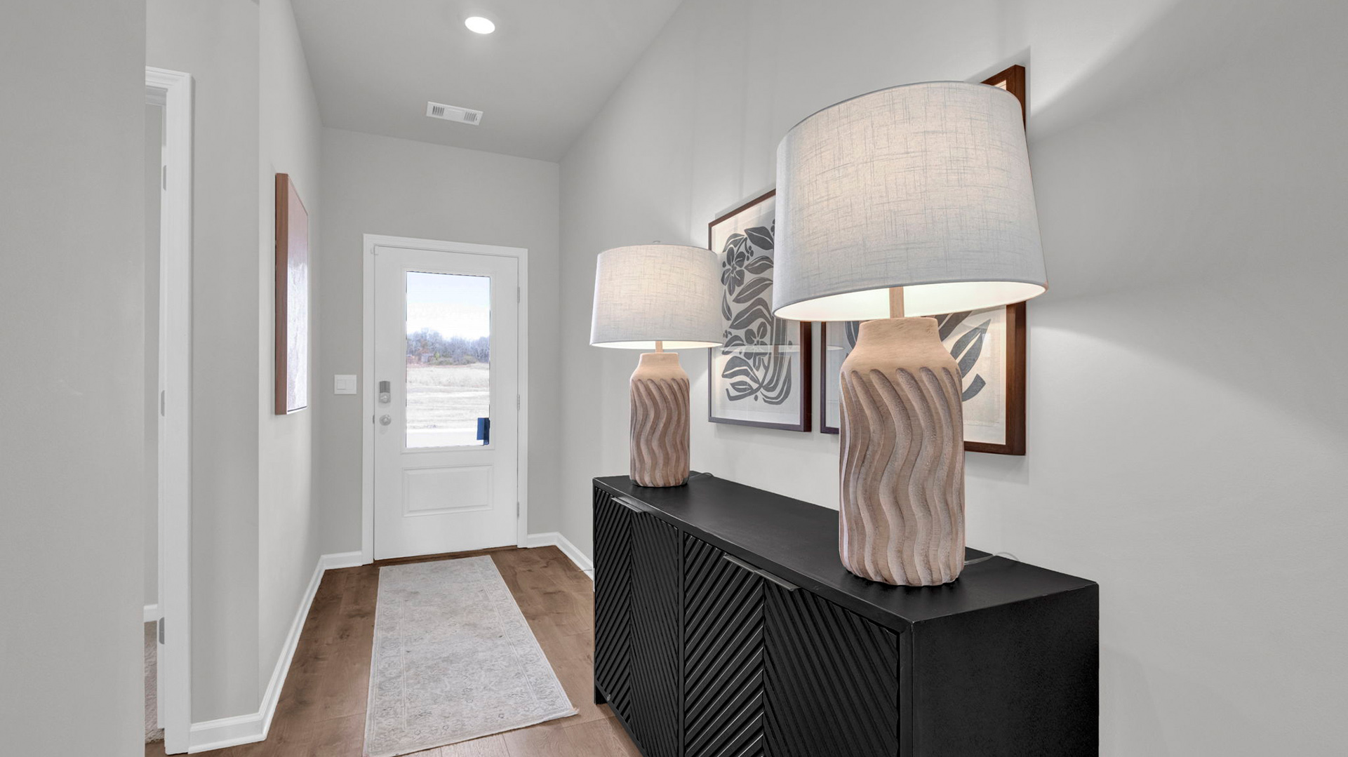 Entry of the DOver model with natural light from front door glass insert