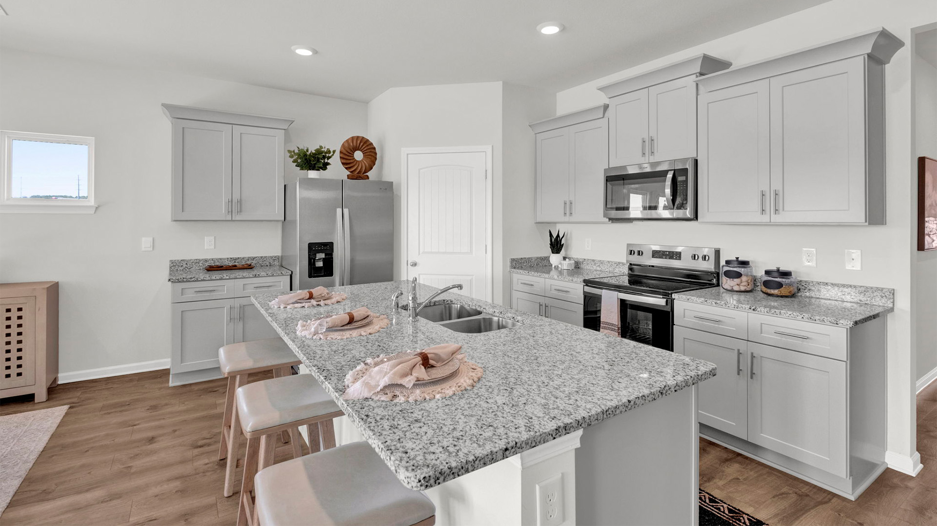 Beautiful kitchen area opens up at the end of long entry hall