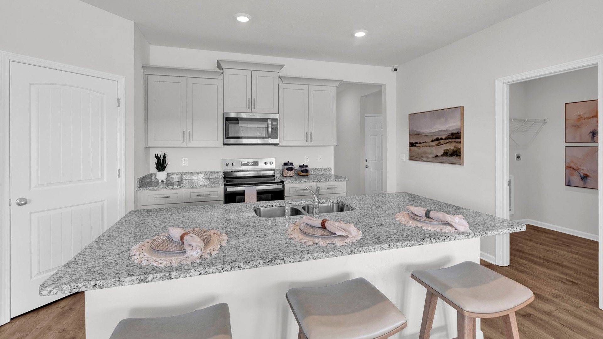 Kitchen area with light cabinets and stainless steel appliances