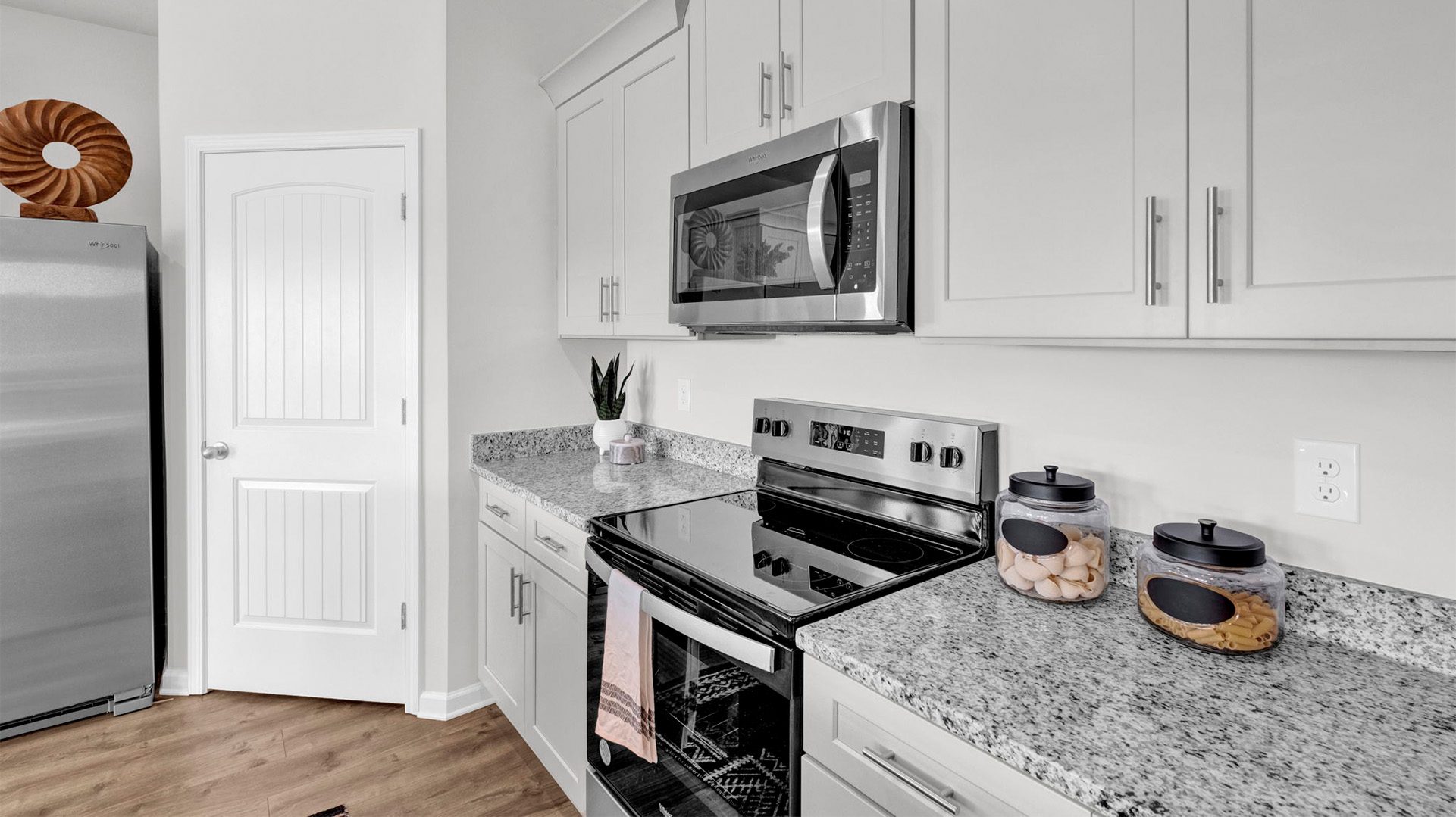 Beautiful light cabinets and granite countertops that come with kitchen