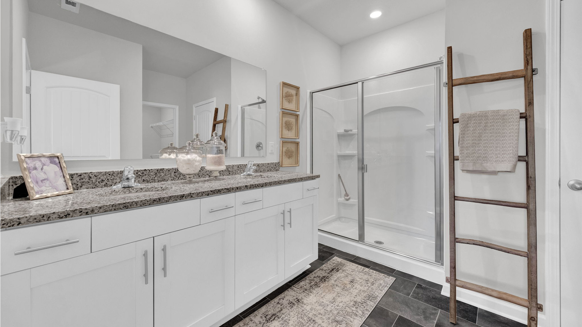 EN suite bathroom with a dual vanity and a walk in shower