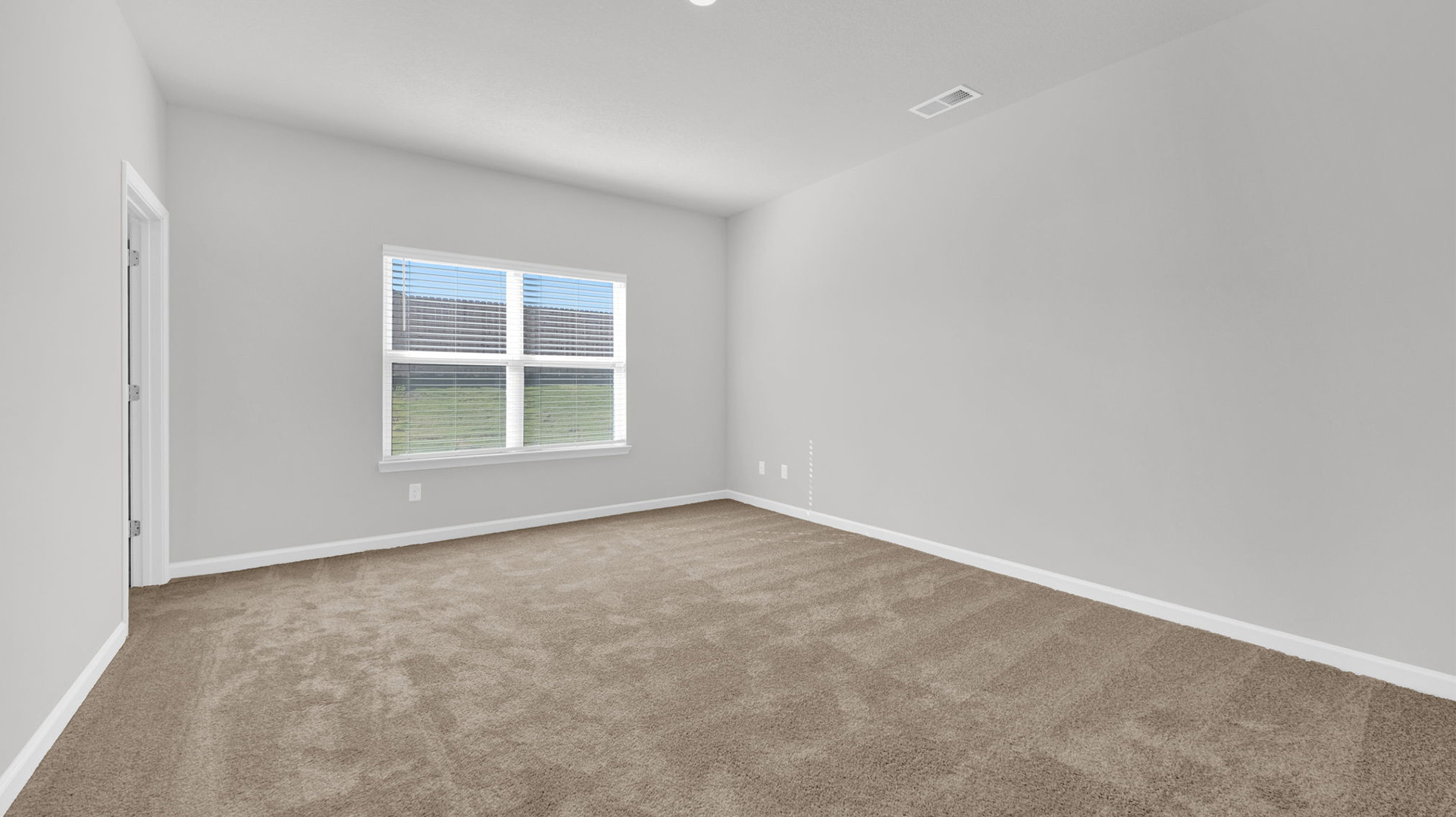 Primary bedroom with a double window for natural light