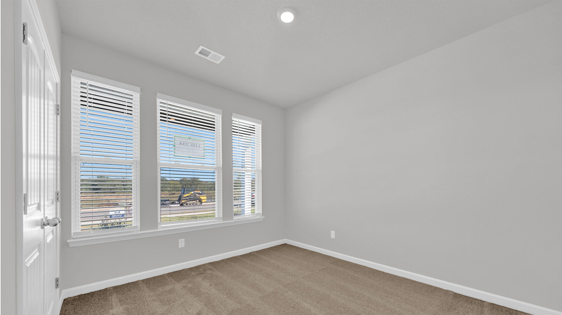Third bedroom sitting at the front of the home with large windows