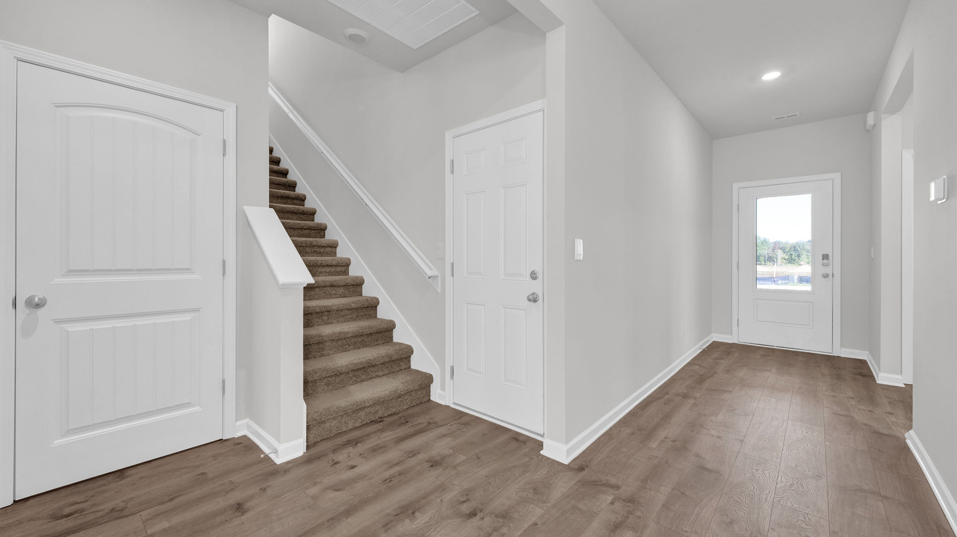 Front door entry leading to the staircase up to the second floor