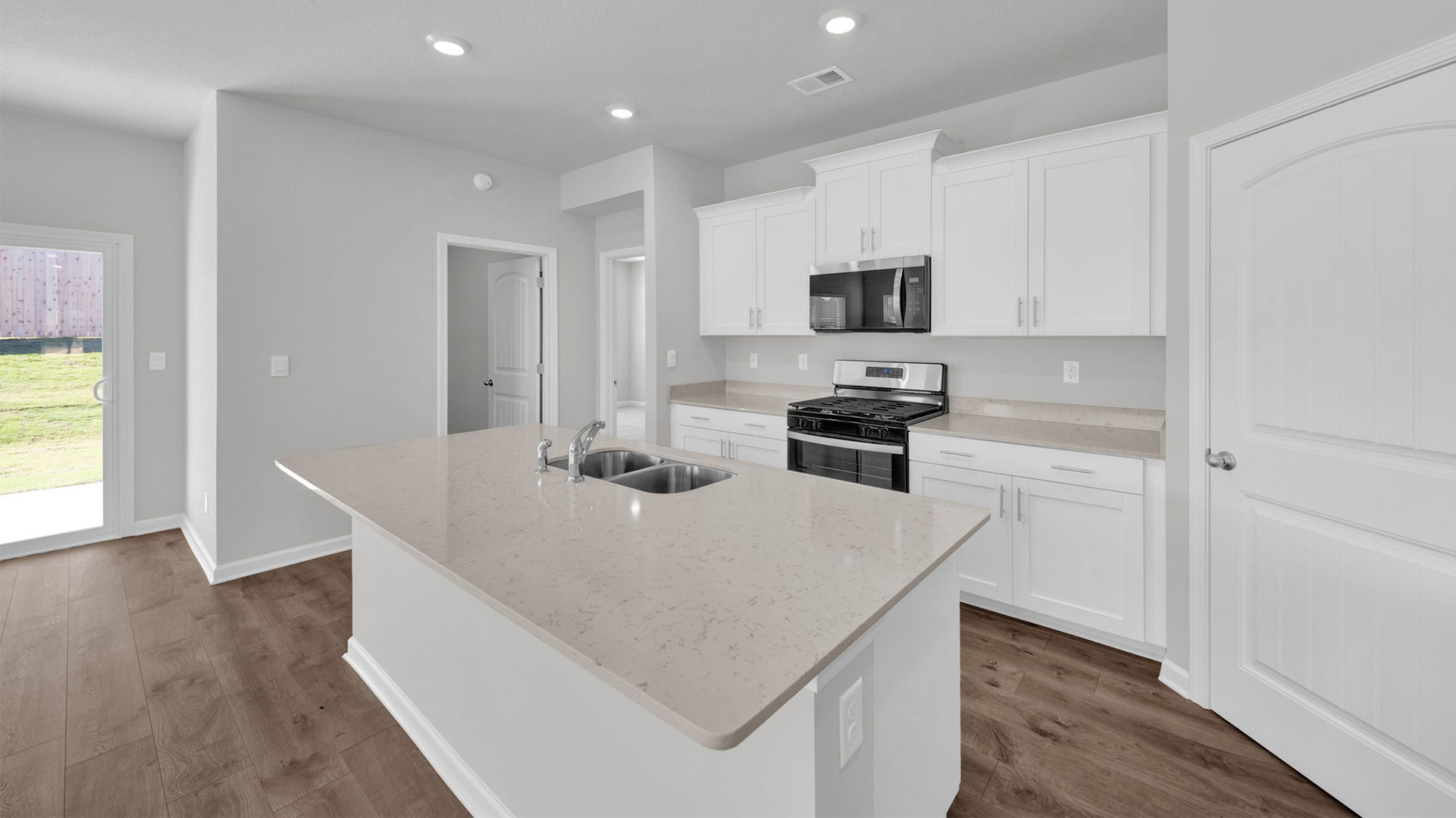 Beautiful kitchen area opens up with recessed lighting