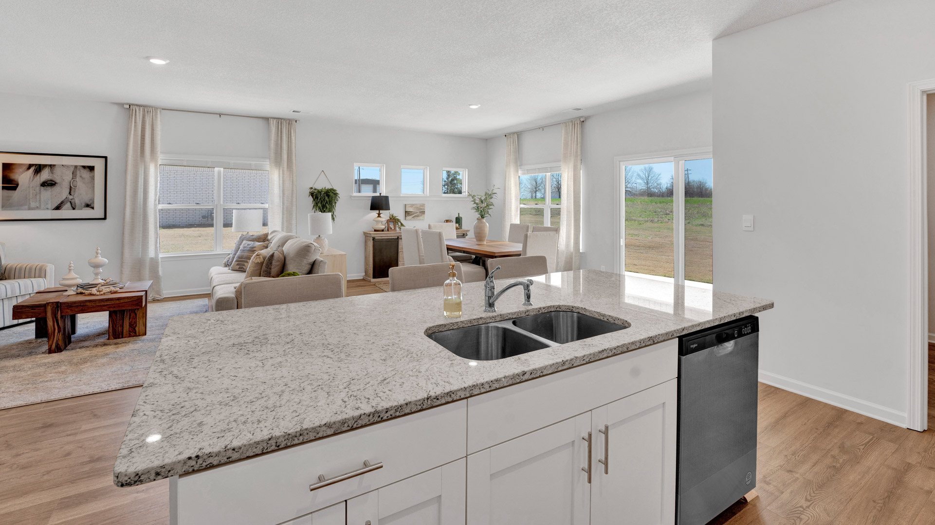 Central kitchen island anchors the home adding a dining option, full sink, pantry and storage, multi-prep zones