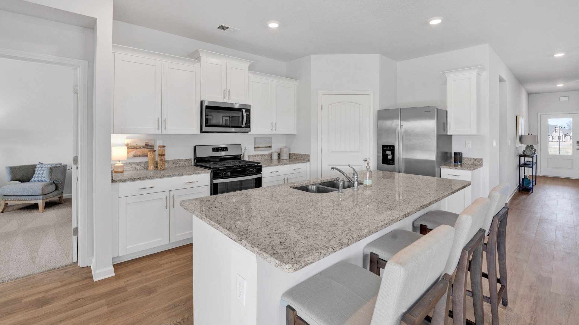 Functional kitchen island adds a sink, multi-prep zones, cabintes and a pantry, new appliance suite, and outside access