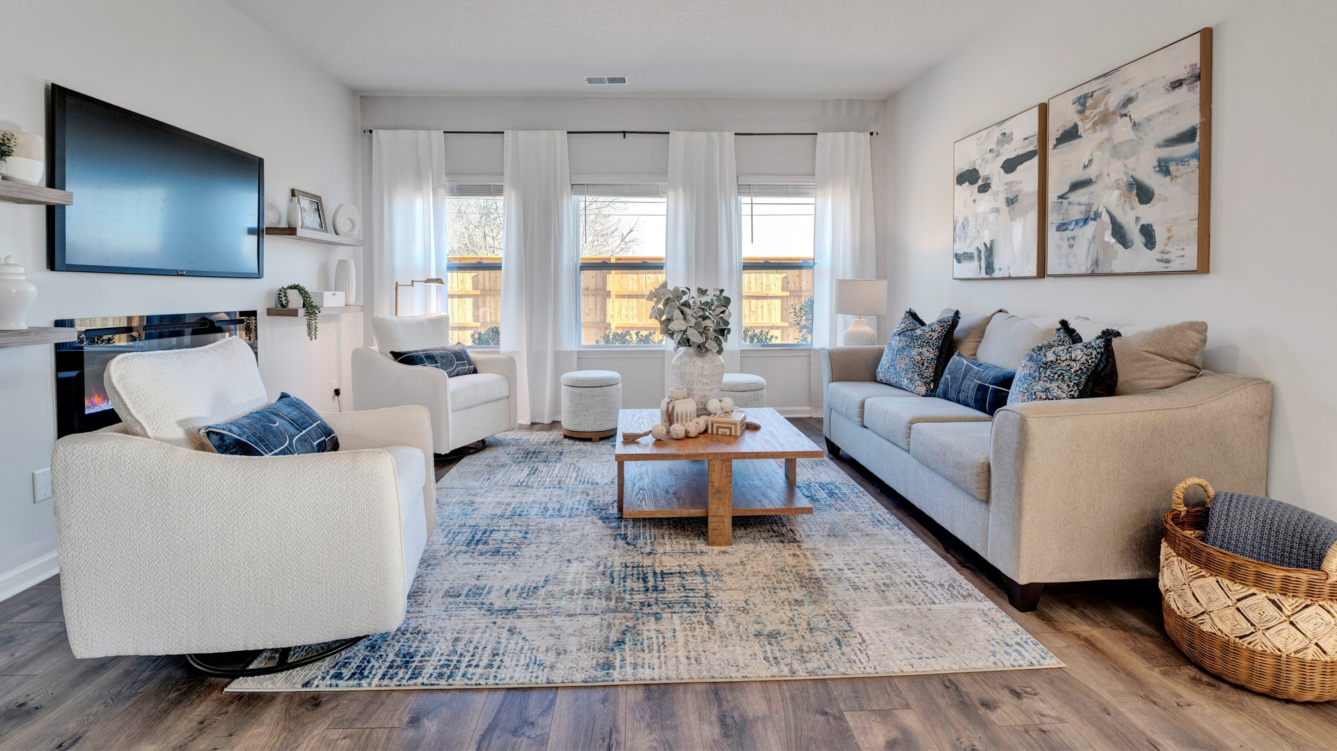 Living room looking to dining and kitchen areas in this new home features natural light, with fresh open concept flow
