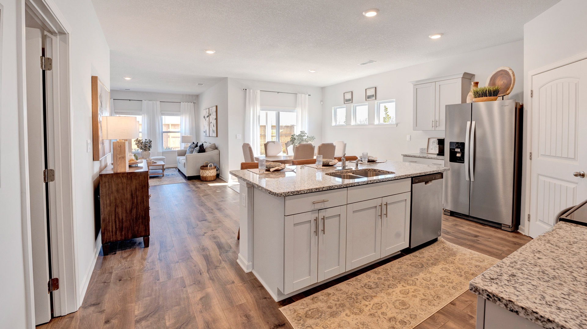 Spacious Kitchen island in this new home with sink, dining areas, daily prep zones, for entertaining and daily life