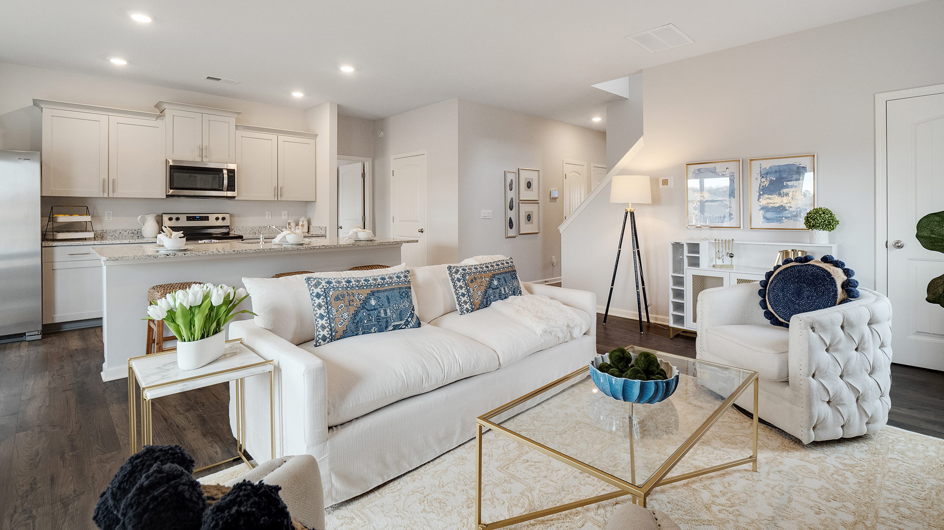Dining room looking toward modern kitchen island with sink and new appliance suite included, next to backyard at Shiloh Springs