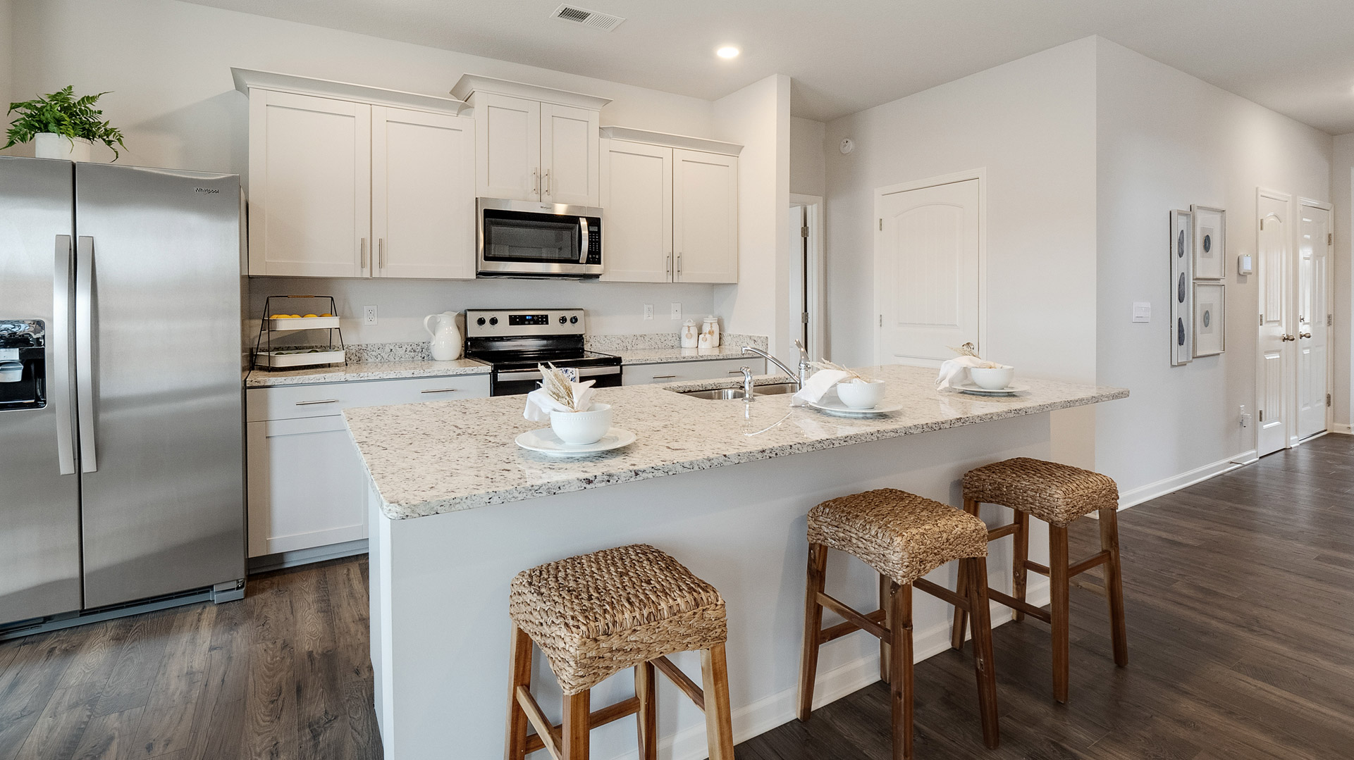 Spacious Kitchen island in this new home with sink, dining areas, daily prep zones, for entertaining and daily life