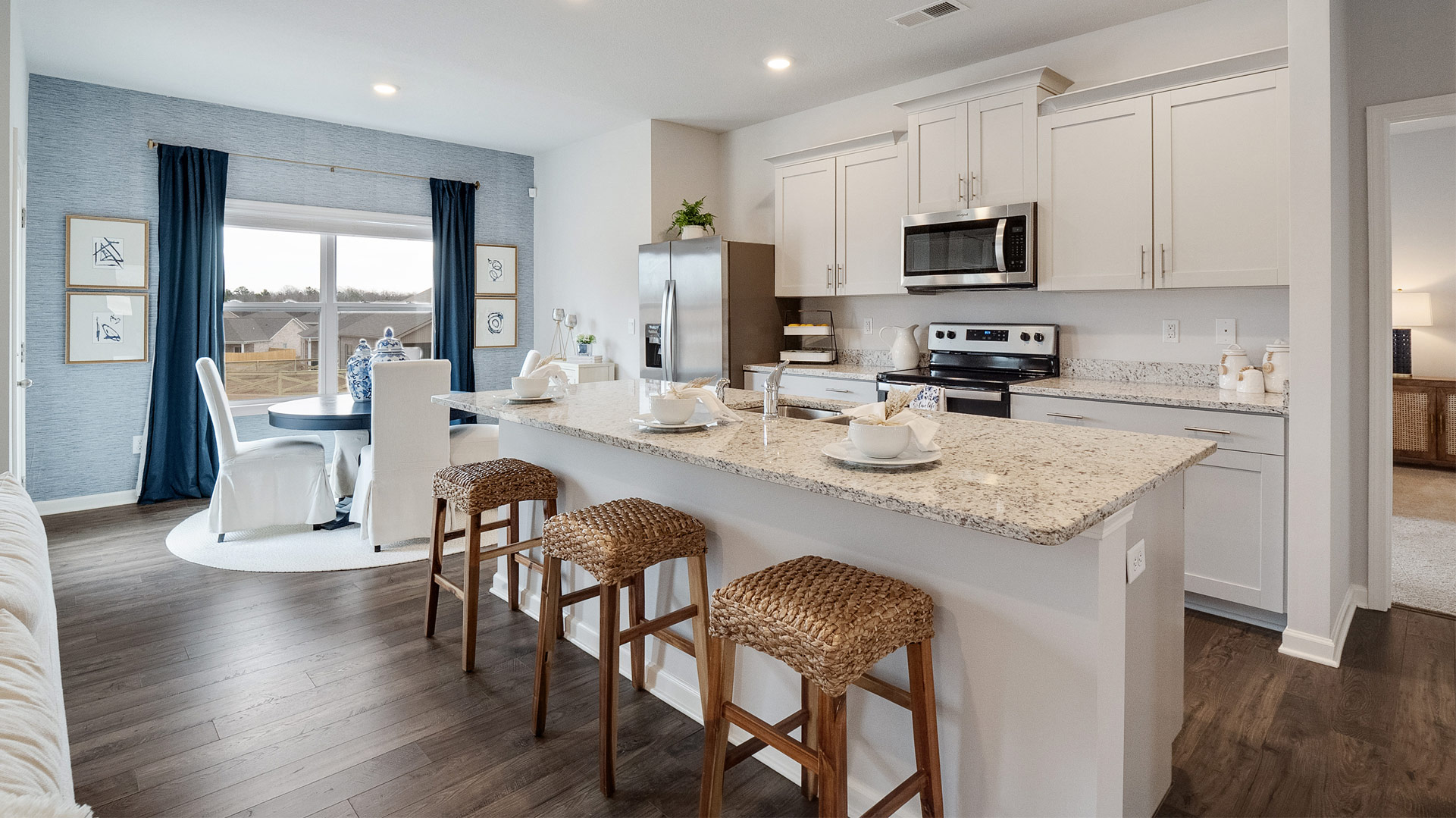 Functional kitchen island adds a sink, multi-prep zones, cabintes and a pantry, new appliance suite, and outside access