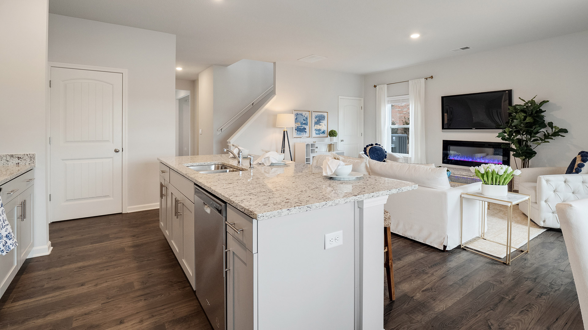 Central kitchen island adds a sink, seating, designed to anchor the home, pantry, prep zones, perfect for entertaining, everyday life