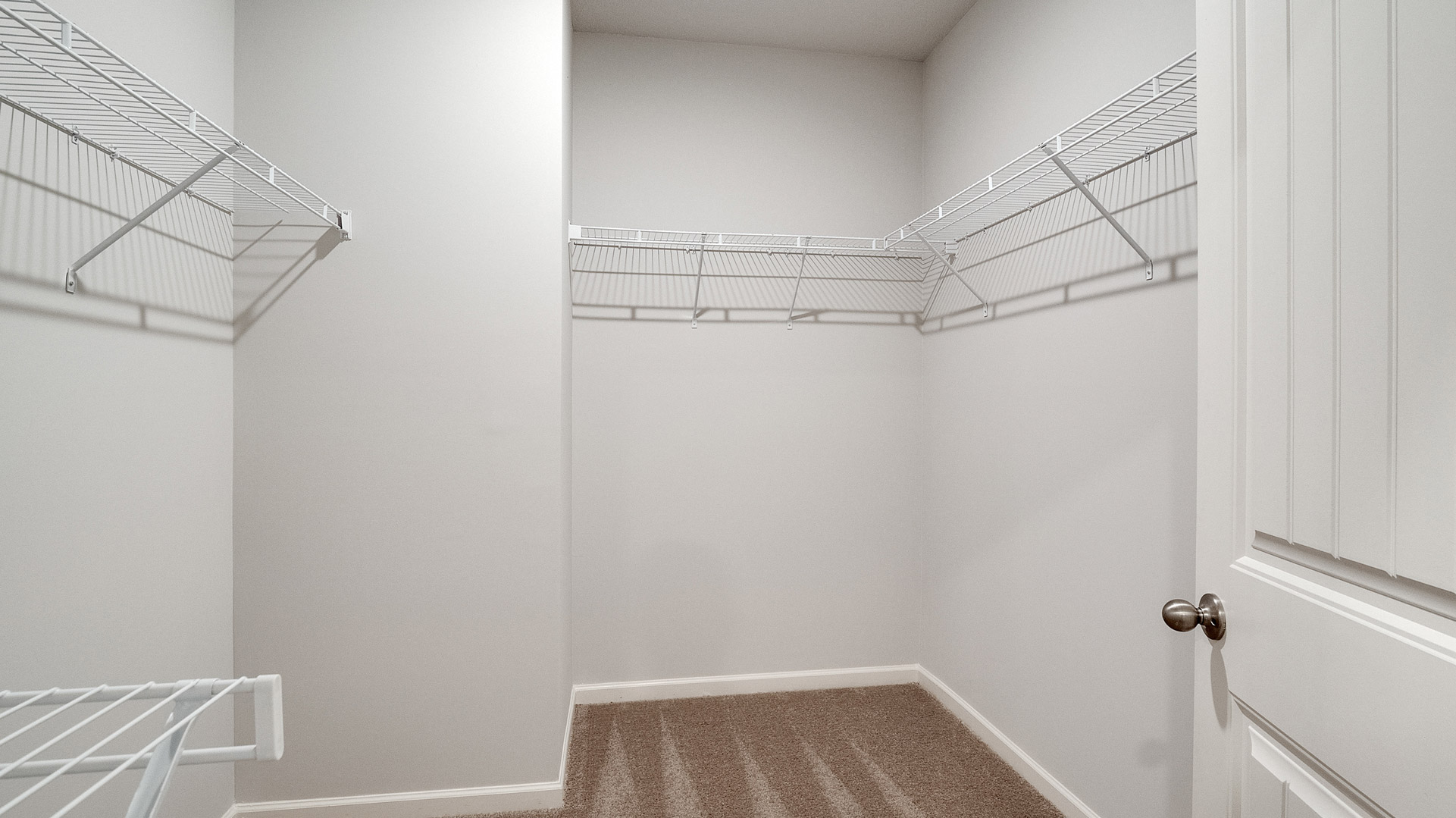 Interior view of walk-in closet in the primary bedroom, spa-inspired ensuite in Shiloh Springs, a new home by D.R. Horton