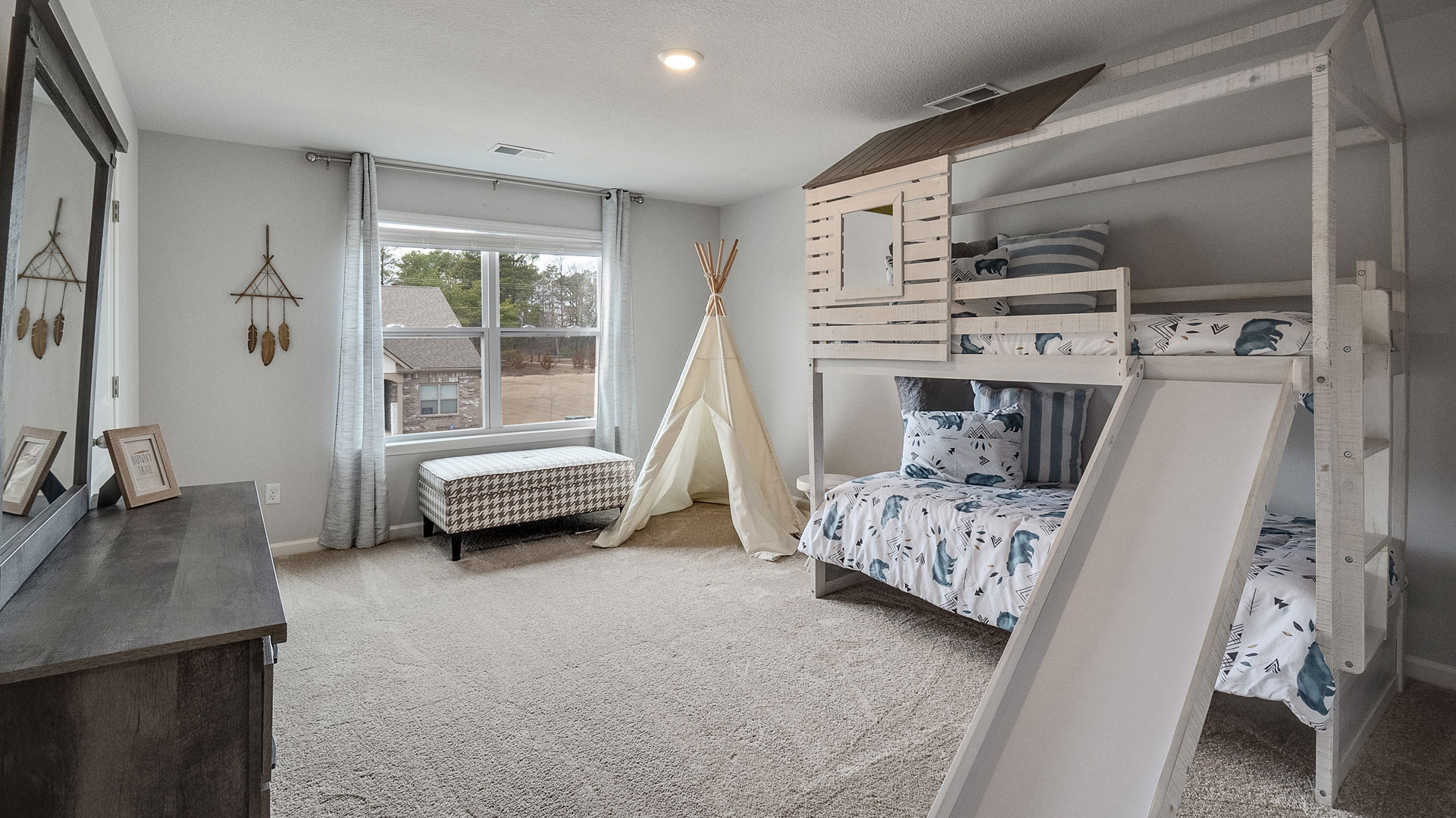 Second bedroom in Shiloh Springs showcases quality designs with closet space, soft window light, upstairs connectivity